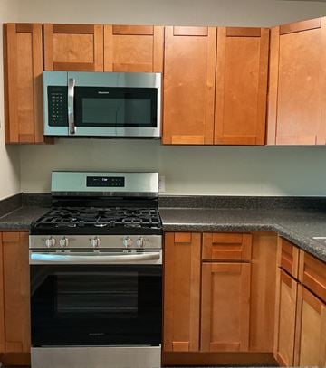 Rockville apartment for rent - A kitchen with a stove and microwave above it.