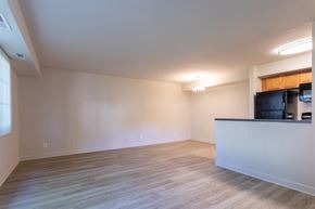 Rockville apartment for rent - A spacious room with a bar counter and wooden flooring.