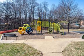 Silver Spring apartment for rent - A playground with a yellow slide and a red bench.
