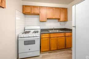 Silver Spring apartment for rent - A kitchen with a stove, sink, and cabinets.