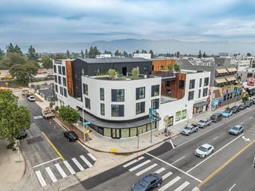 Toluca Lake apartment for rent - A street view of a city with cars and buildings.