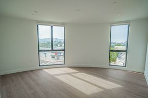 Toluca Lake apartment for rent - A large empty room with wooden floors and two windows.