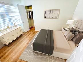 Cocoa Beach apartment for rent - A bedroom with a bed, nightstand, and a dresser with a mirror.