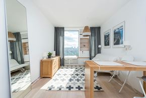 Austin apartment for rent - A well-lit, modern bedroom with a large window and a view of the city.