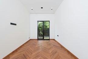 San Francisco apartment for rent - A room with a wooden floor and a glass door leading outside.