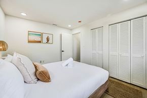 Merritt Island apartment for rent - A bedroom with a large bed and a wardrobe.