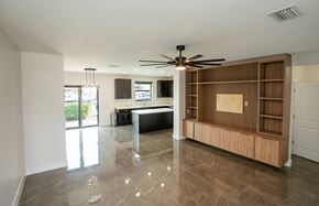 Davie apartment for rent - A spacious room with a ceiling fan and a large wooden cabinet.