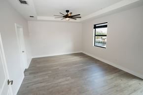 Davie apartment for rent - A room with a ceiling fan and a window overlooking a pool.