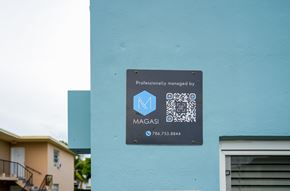 Miami apartment for rent - A sign on a building that says "Professionally managed by MAGASI" with a phone number.