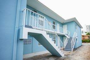 Miami apartment for rent - A blue building with a white staircase.