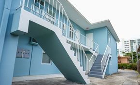 Miami apartment for rent - A blue building with a white staircase.