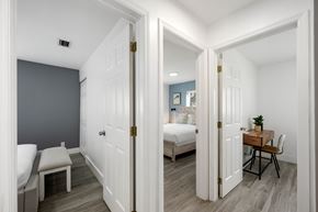 Pompano Beach apartment for rent - A white door opens to reveal a bedroom with a bed and a desk.