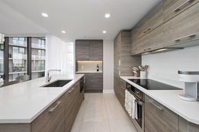 Miami apartment for rent - A modern kitchen with a large island and stainless steel appliances.