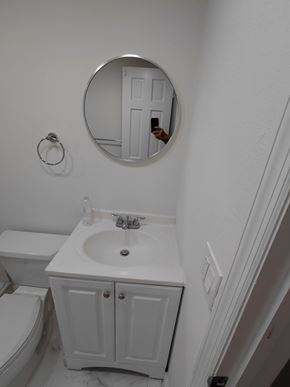 Miami apartment for rent - A bathroom with a white toilet, sink and cabinet.