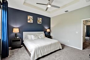 Miami apartment for rent - A bedroom with a bed, two nightstands with lamps, and a ceiling fan.