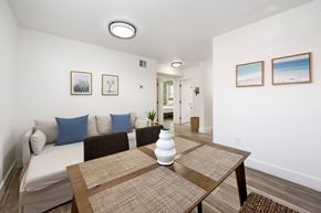 Miami apartment for rent - A dining room with a brown table and a white couch.