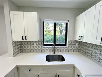 Miami triplex for rent - A kitchen with a sink and cabinets.