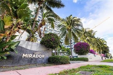 Miami Beach apartment for rent - A building with the name "MIRADOR" on it is surrounded by palm trees.