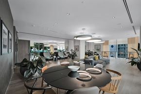 Miami apartment for rent - A modern dining area with a long table and chairs.