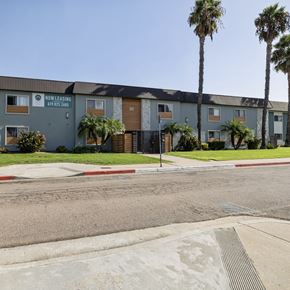 El Cajon apartment for rent - A street view of a Now Leasing sign in front of a building.