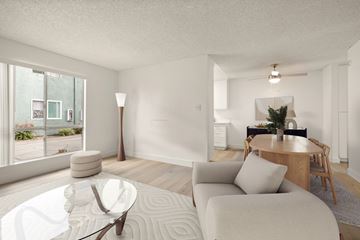 El Cajon apartment for rent - A modern living room with a glass table and a white couch.