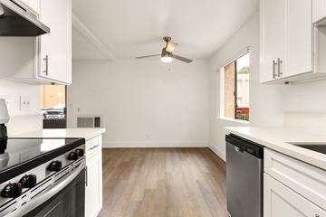 Ramona apartment for rent - A kitchen with a black stove top oven and white cabinets.