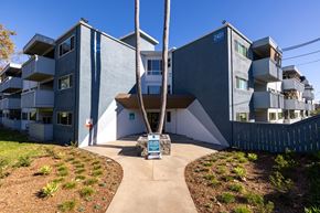 San Diego apartment for rent - A modern building with a blue sign that reads