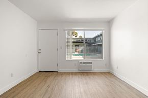 El Cajon apartment for rent - A room with a white door and a window with a view of a building.
