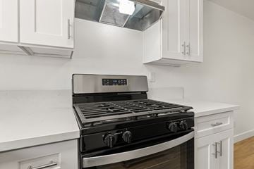 El Cajon apartment for rent - A modern kitchen with a black stove top oven.