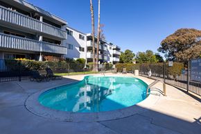 San Diego apartment for rent - A swimming pool in a courtyard surrounded by buildings.