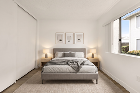Ramona apartment for rent - A bedroom with a bed, nightstands, and a window.