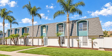 El Cajon apartment for rent - A row of houses with palm trees in front.