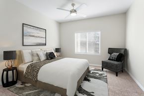 Turlock apartment for rent - A bedroom with a large bed and a painting on the wall.