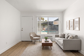 El Cajon apartment for rent - A living room with a grey couch, a chair, and a coffee table.