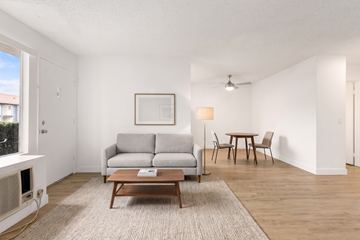 Ramona apartment for rent - A living room with a grey couch, a brown coffee table, and a painting on the wall.