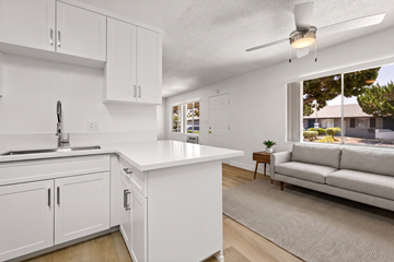 El Cajon apartment for rent - A white kitchen with a couch in the living room.