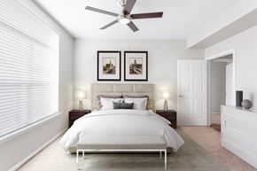 Modesto apartment for rent - A bedroom with a large bed and two picture frames on the wall.