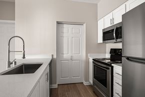 Olympia apartment for rent - A kitchen with a sink, stove, and oven.