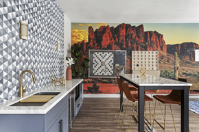 Las Vegas apartment for rent - A kitchen with a table and chairs in front of a desert mural.