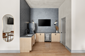 Las Vegas apartment for rent - A modern kitchen with wooden cabinets and a grey backsplash.