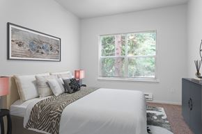 Gresham apartment for rent - A bedroom with a large bed and a painting on the wall.