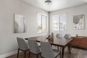 Surprise apartment for rent - A dining room with a wooden table and grey chairs.