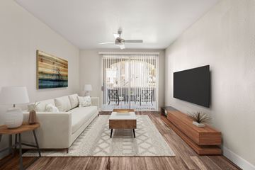 Glendale apartment for rent - A living room with a white couch, a wooden coffee table, and a painting on the wall.