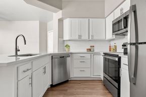 Glendale apartment for rent - A modern kitchen with white cabinets and stainless steel appliances.
