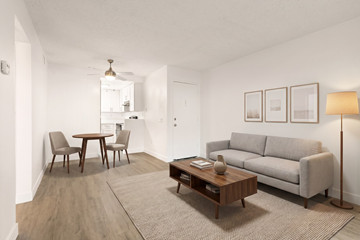 Ramona apartment for rent - A living room with a grey couch, a coffee table, and a dining table with chairs.