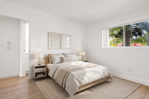 El Cajon apartment for rent - A bedroom with a large bed, two nightstands, and a window.