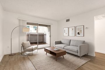Ramona apartment for rent - A living room with a grey couch, a chair, a table and pictures on the wall.