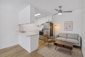 Ramona apartment for rent - A modern kitchen with white cabinets and a wooden floor.