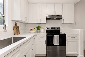 Ramona apartment for rent - A modern kitchen with a black stove top oven.