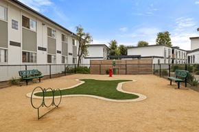 El Cajon apartment for rent - A playground area with a slide, swings, and a sandbox.